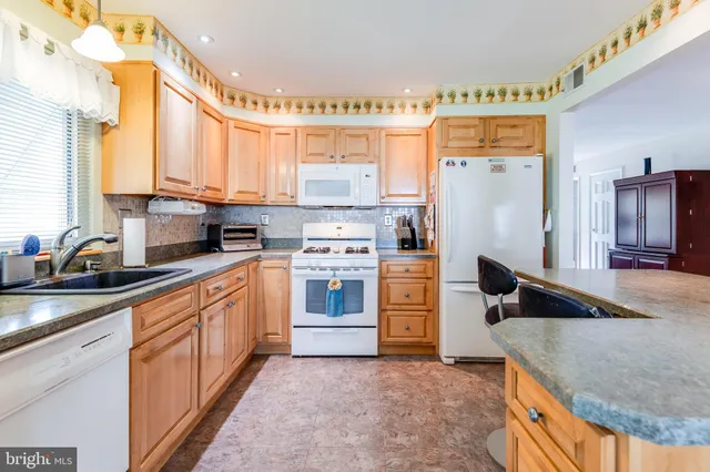 a kitchen with a refrigerator sink and stove