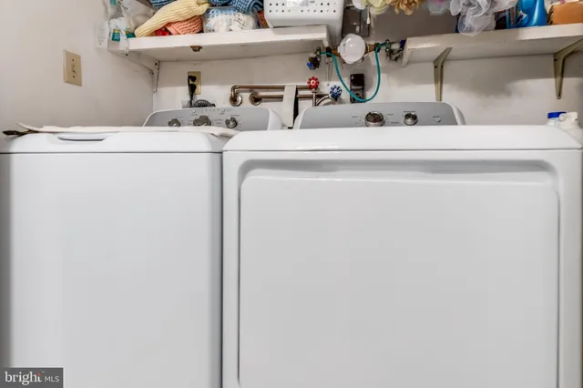 a close view of laundry room with furniture and washer