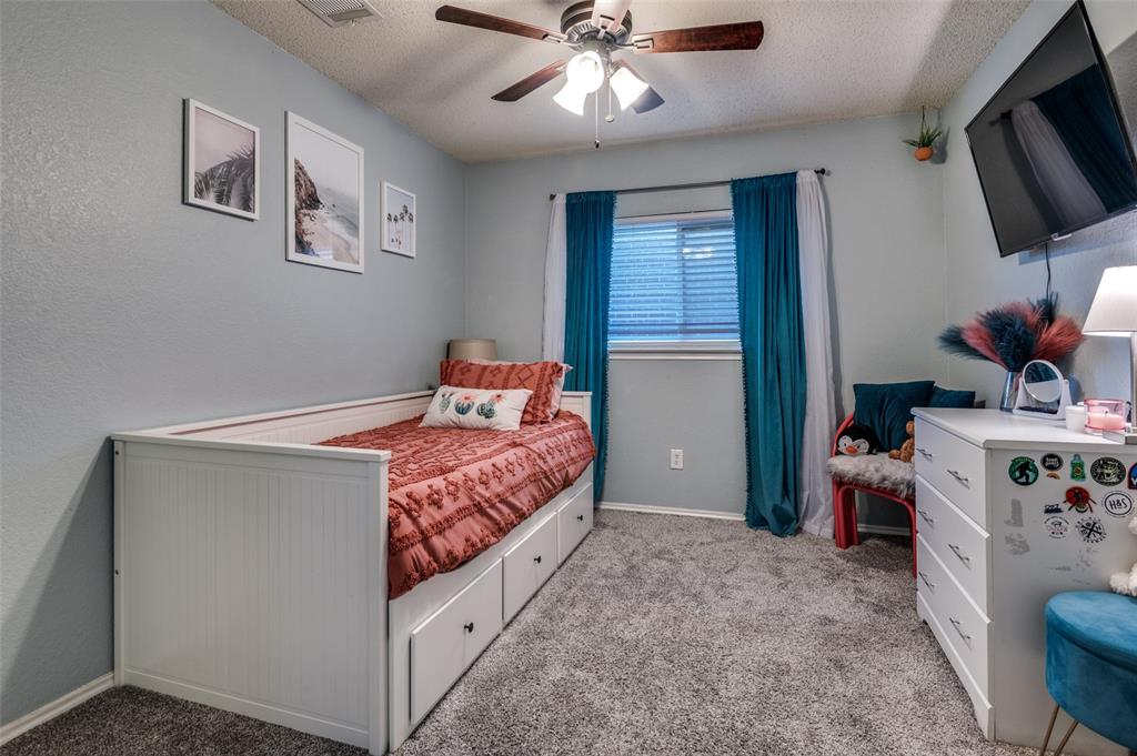 656 Condor Trail Saginaw, TX 76131 - Photo 16 of 25 a bedroom with a bed and flat screen tv