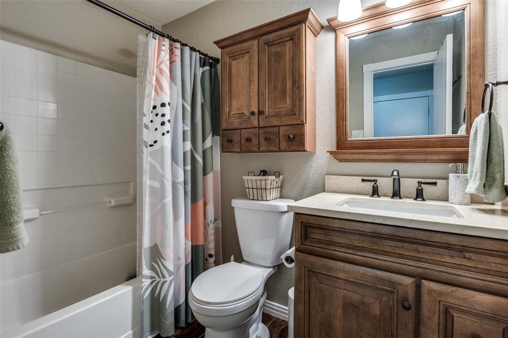 656 Condor Trail Saginaw, TX 76131 - Photo 17 of 25 a bathroom with a granite countertop toilet sink and mirror