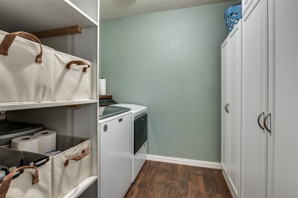 656 Condor Trail Saginaw, TX 76131 - Photo 18 of 25 a utility room with cabinets washer and dryer