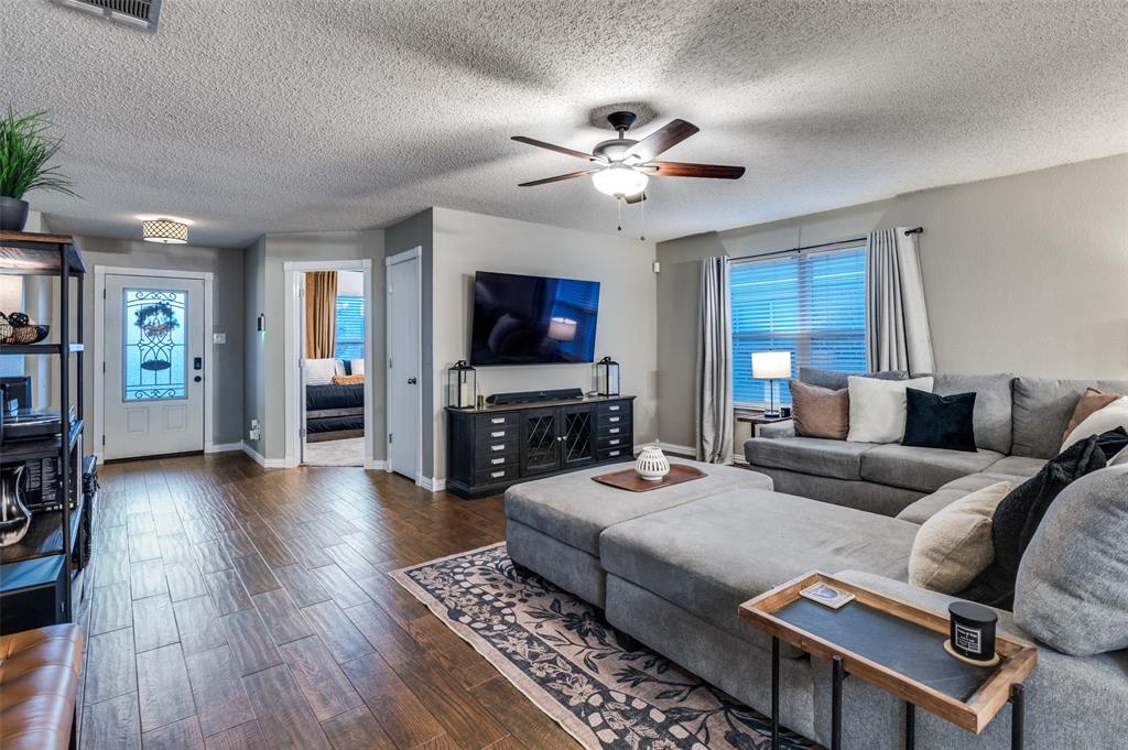 656 Condor Trail Saginaw, TX 76131 - Photo 3 of 25 a living room with furniture a flat screen tv and a rug