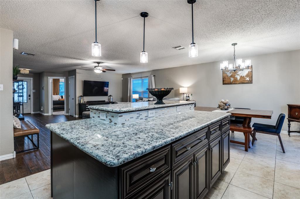656 Condor Trail Saginaw, TX 76131 - Photo 10 of 25 a kitchen with a counter a sink and chairs