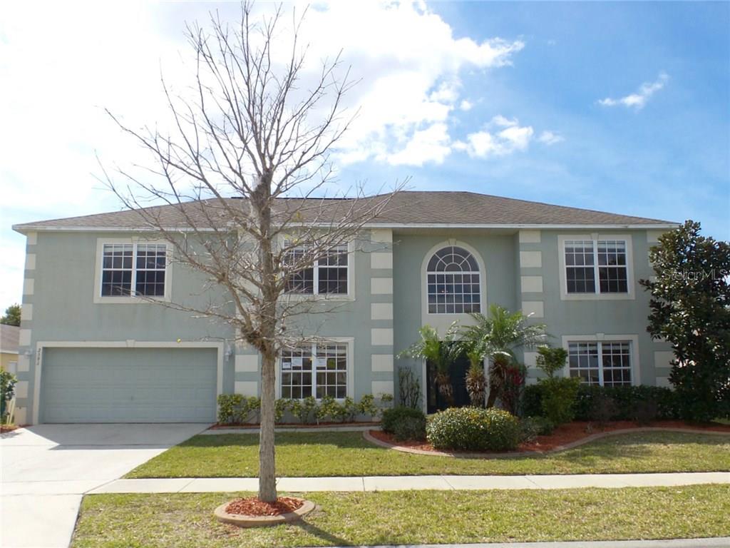 2591 Hunley Loop Kissimmee, FL 34743 - Photo 1 of 1 a front view of a house with garden