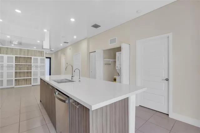 a kitchen with a sink and a refrigerator