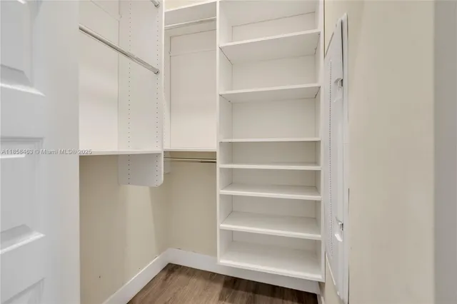 a view of walk in closet with empty racks