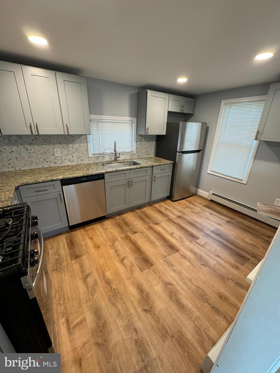 509 Laurel Street Beverly, NJ 08010 - Photo 30 of 47 a large kitchen with kitchen island granite countertop a refrigerator and a sink