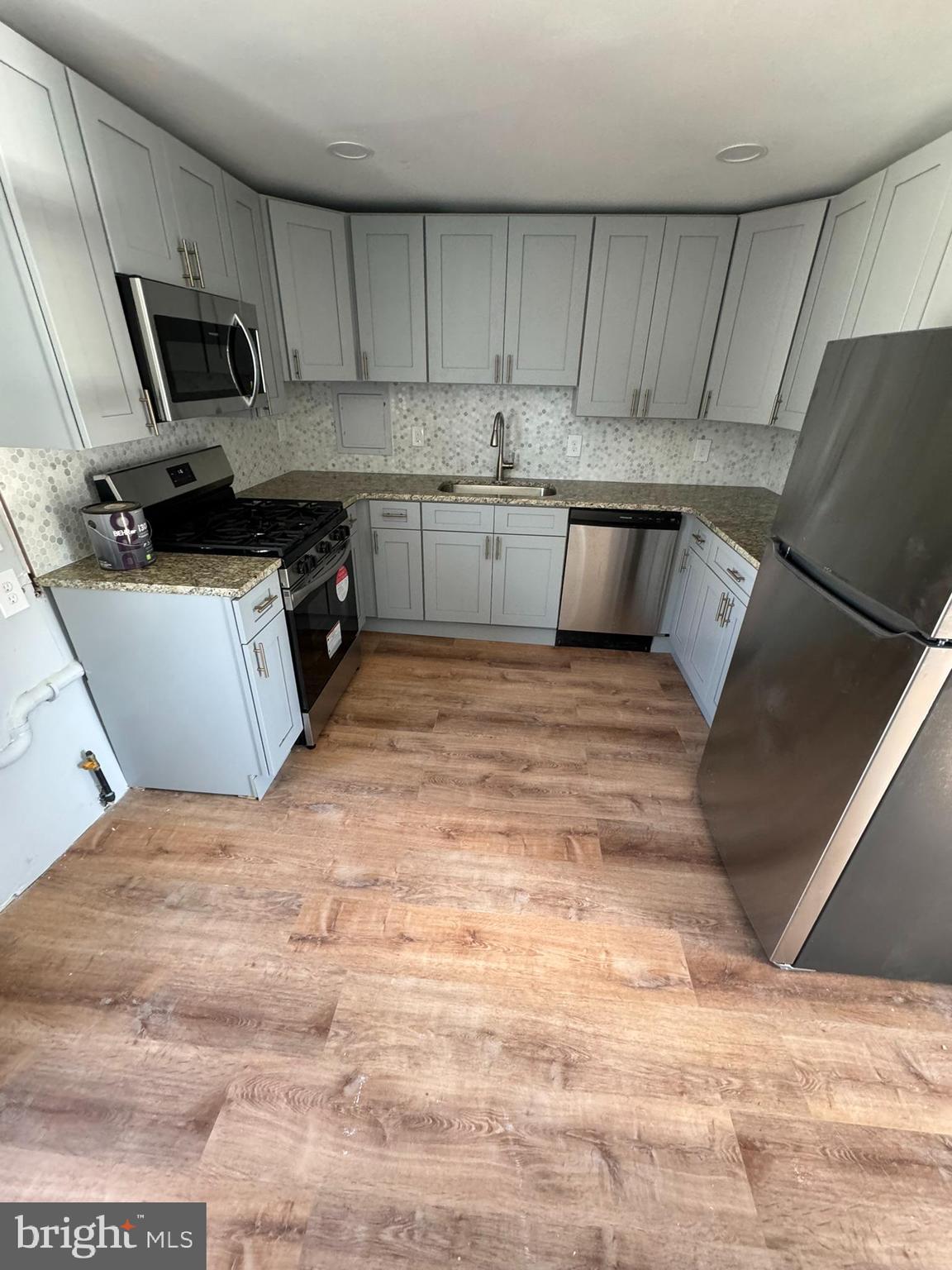 509 Laurel Street Beverly, NJ 08010 - Photo 37 of 47 a kitchen with stainless steel appliances granite countertop a sink a stove top oven a granite counter tops and white cabinets