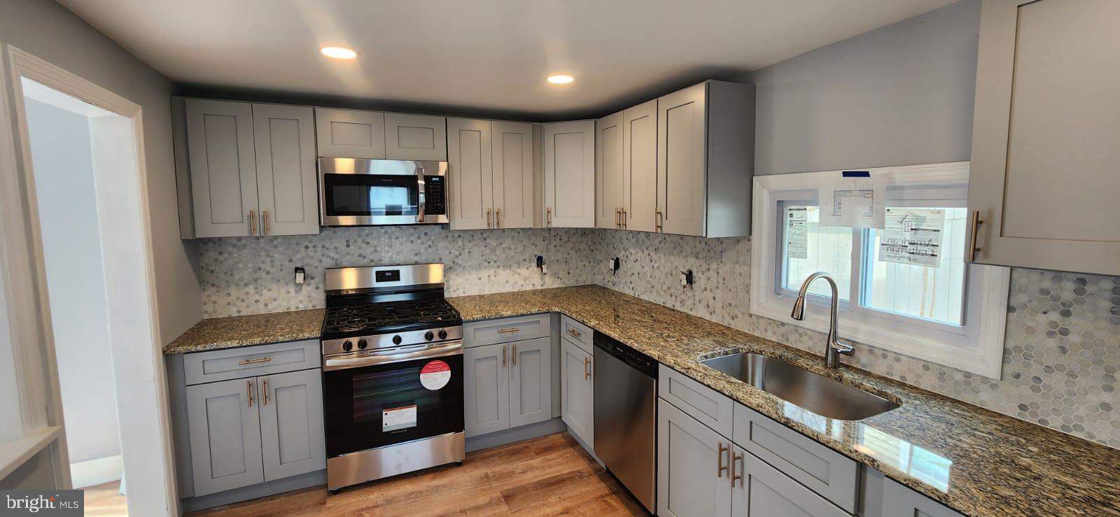 509 Laurel Street Beverly, NJ 08010 - Photo 4 of 47 a kitchen with granite countertop a sink stainless steel appliances and cabinets