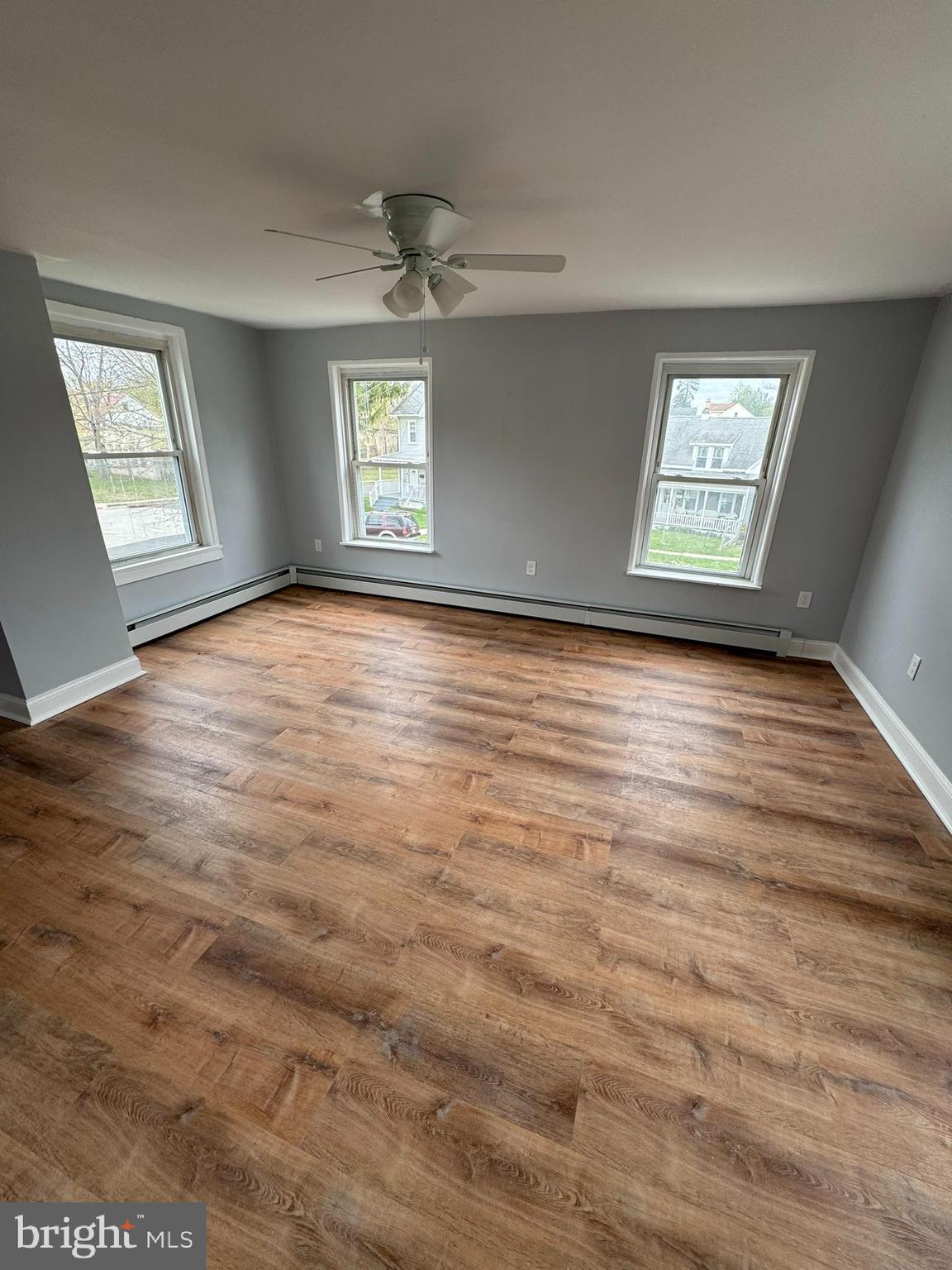 509 Laurel Street Beverly, NJ 08010 - Photo 45 of 47 an empty room with wooden floor and windows