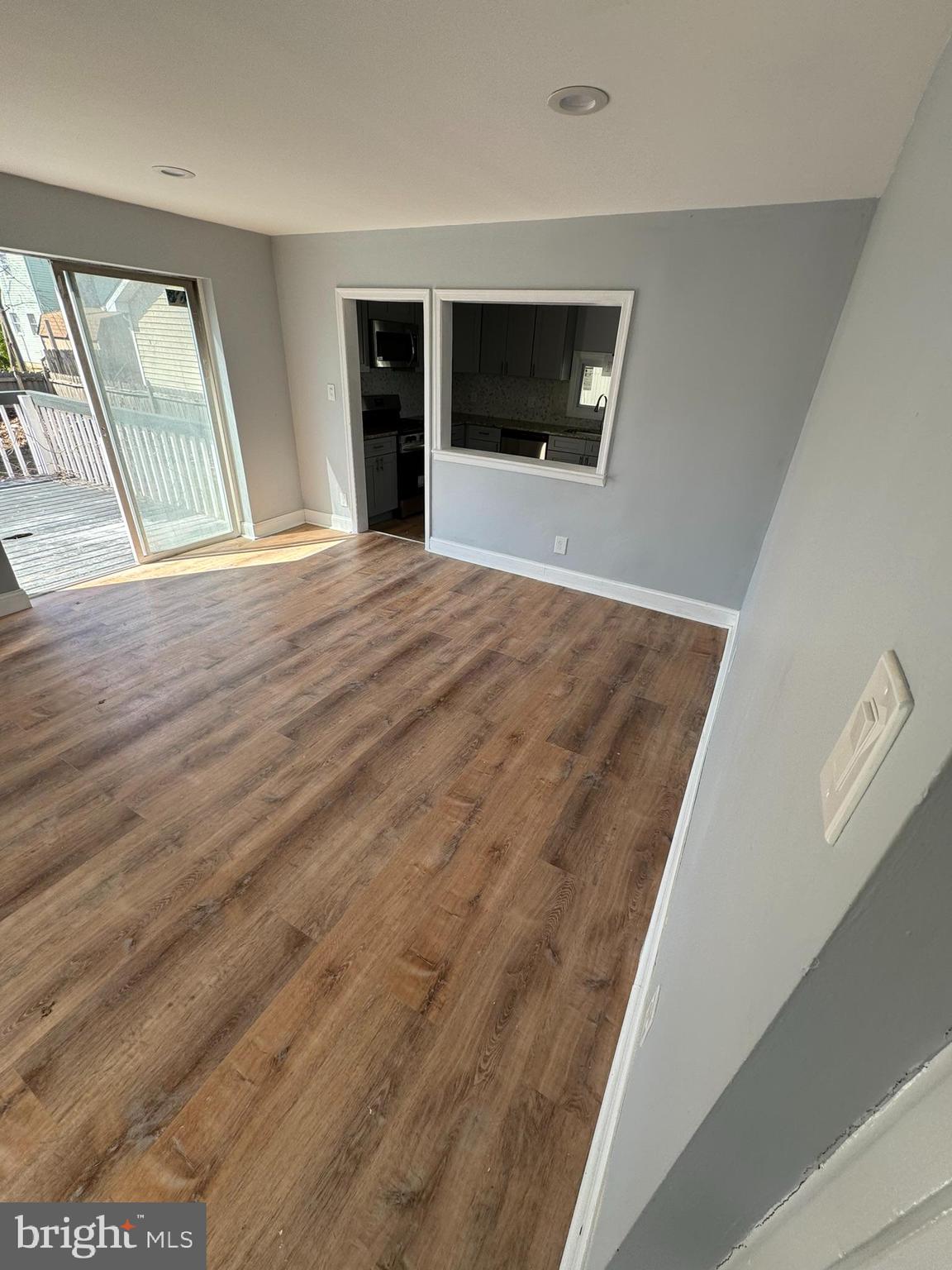 509 Laurel Street Beverly, NJ 08010 - Photo 9 of 47 a view of an empty room with wooden floor and a window
