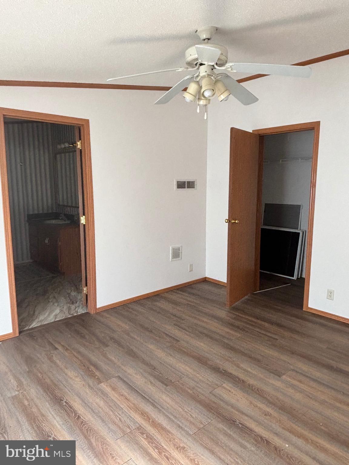 3825 Dickenson Mountain Road Franklin, WV 26807 - Photo 9 of 32 a view of an empty room with wooden floor and a ceiling fan