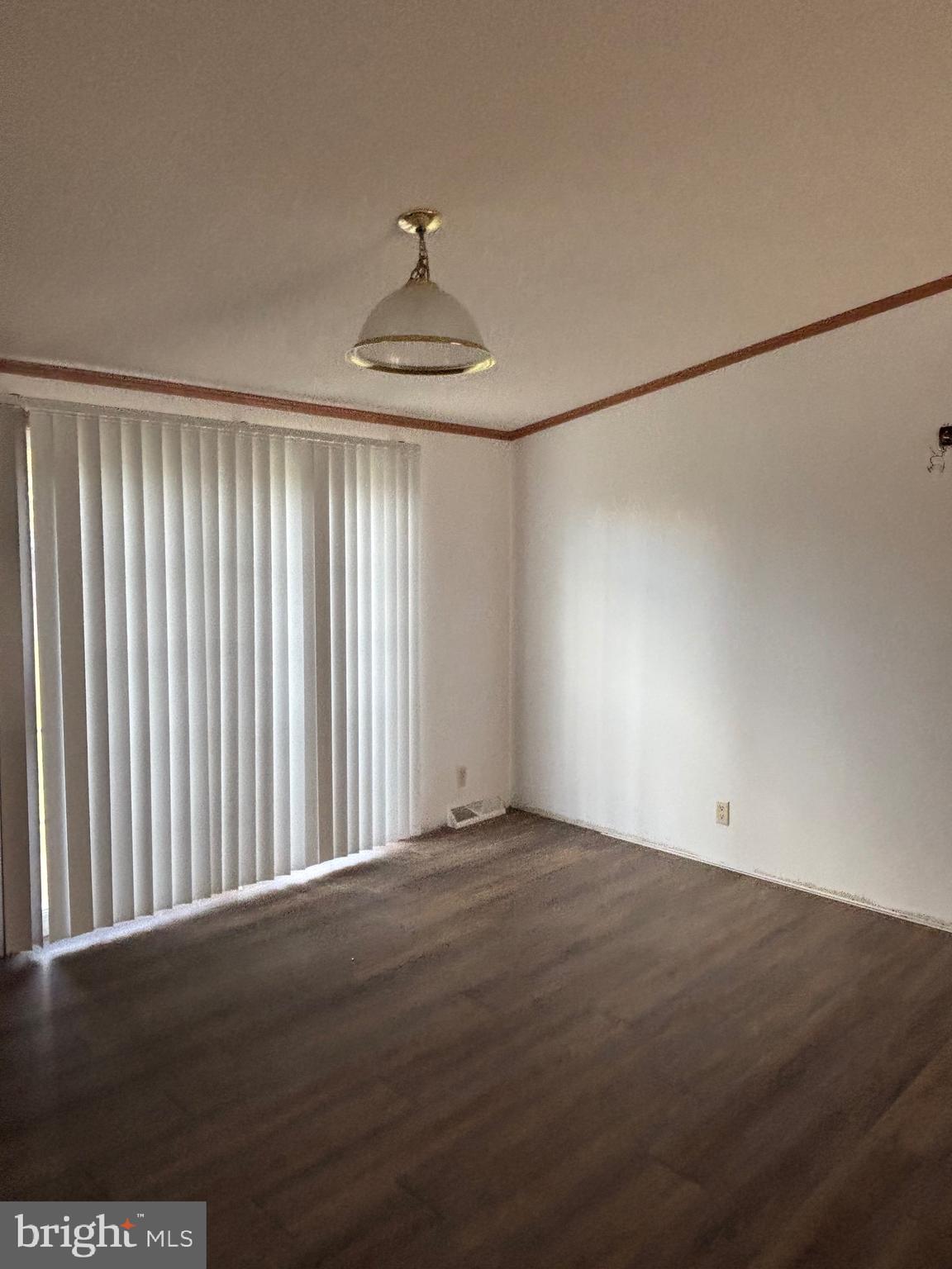 3825 Dickenson Mountain Road Franklin, WV 26807 - Photo 10 of 32 an empty room with wooden floor and chandelier