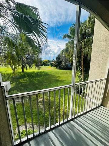 a view of a balcony with a yard