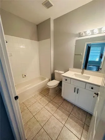 a bathroom with a double vanity sink mirror and toilet