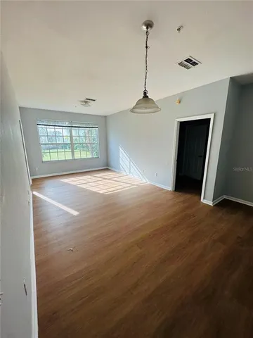 a big room with closet and windows