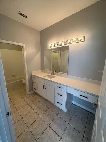 a spacious bathroom with a double vanity sink mirror and