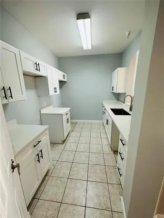 a kitchen with stainless steel appliances a stove a sink and a refrigerator