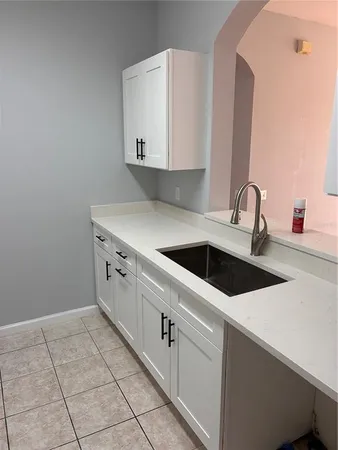 a kitchen with a sink cabinets and utility