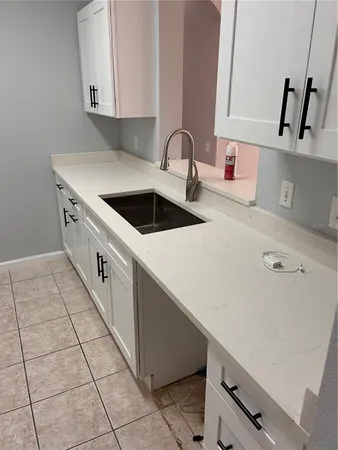 a kitchen with a sink cabinets and appliances