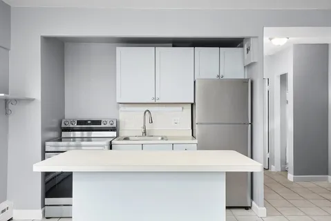 a kitchen with appliances a sink and a refrigerator