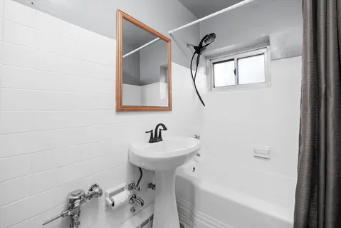 a bathroom with a sink a toilet and bathtub