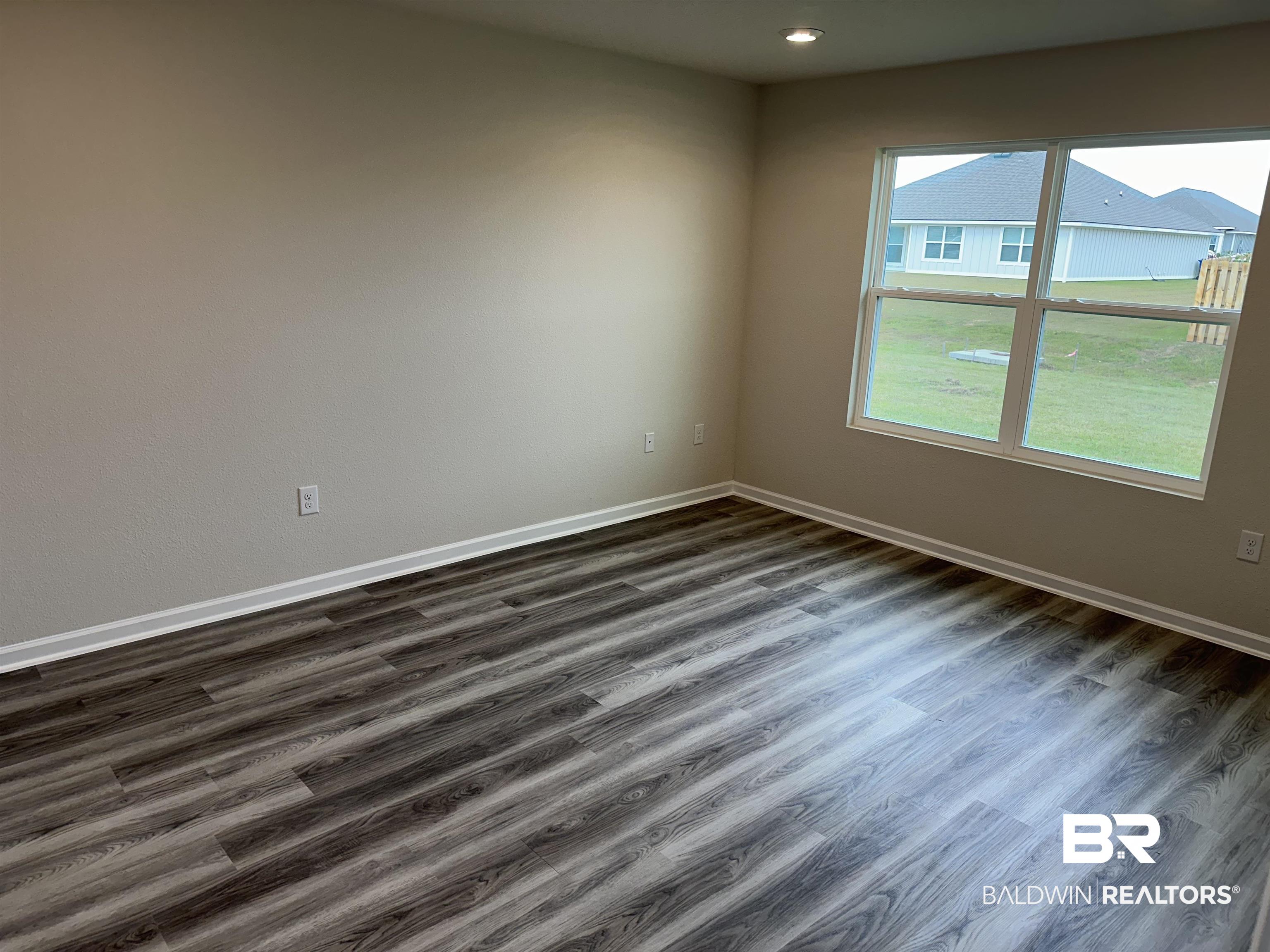 1238 Hayward Loop Foley, AL 36535 - Photo 29 of 46 Spare room featuring dark wood-type flooring