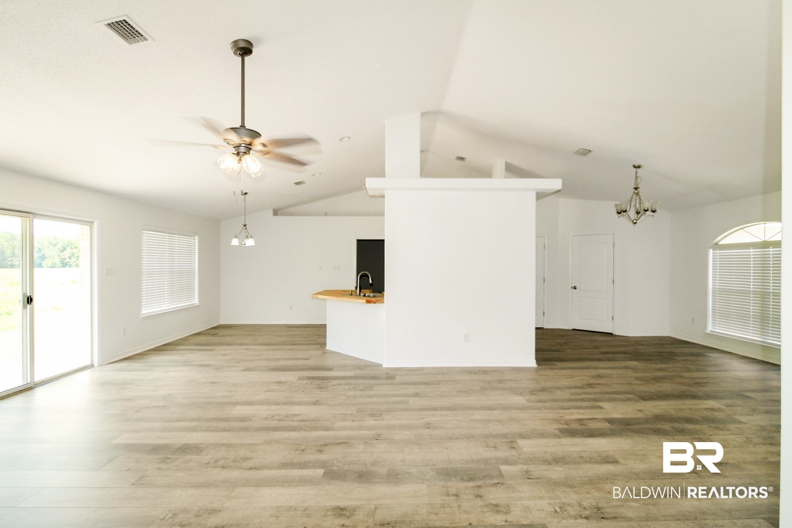 14750 Pawnee Court Foley, AL 36535 - Photo 15 of 34 Unfurnished living room with a chandelier, light wood-type flooring, a ceiling fan, and lofted ceiling