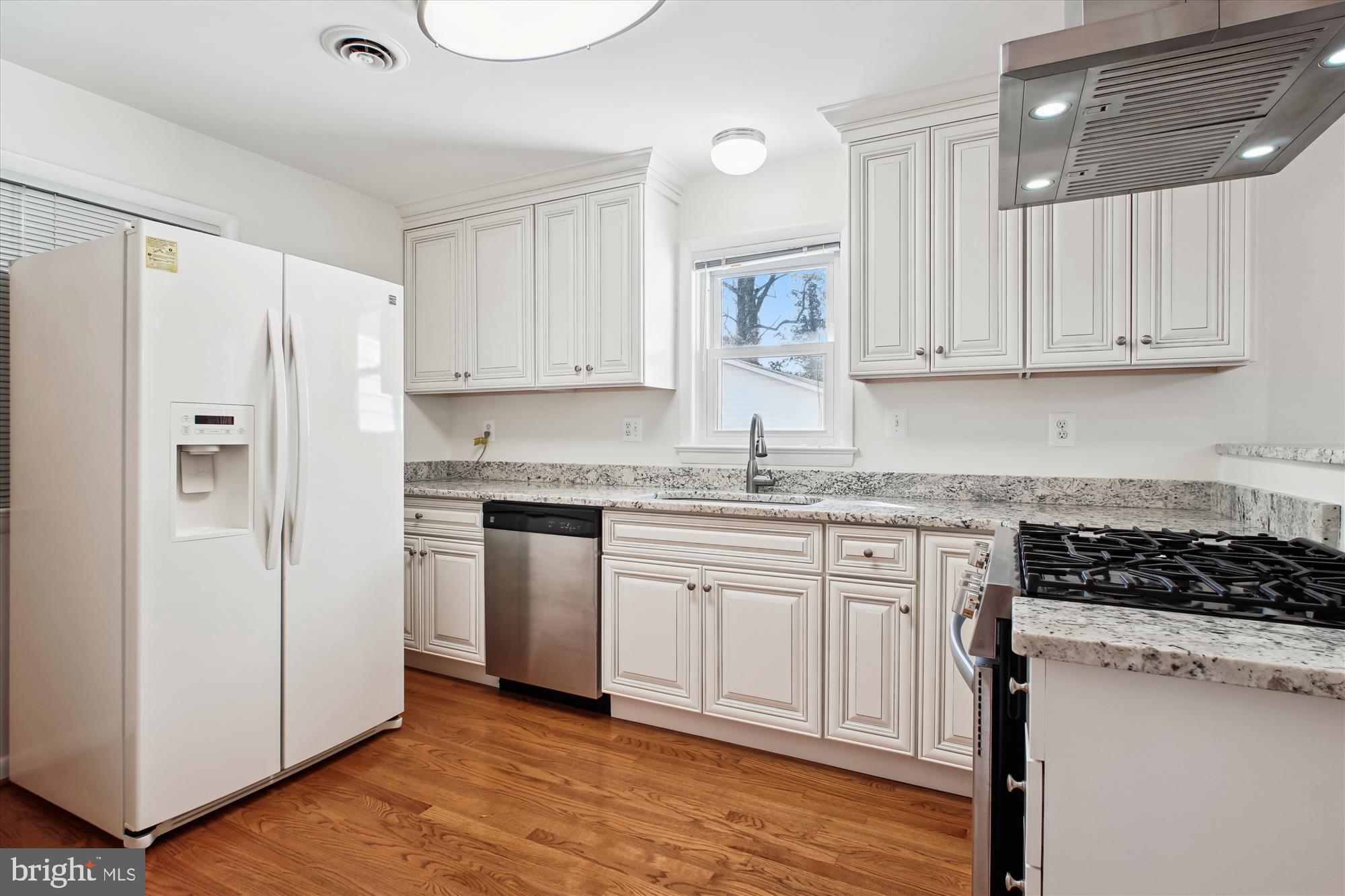 10607 Judicial Drive Fairfax, VA 22030 - Photo 22 of 60 a kitchen with stainless steel appliances granite countertop a refrigerator sink and white cabinets