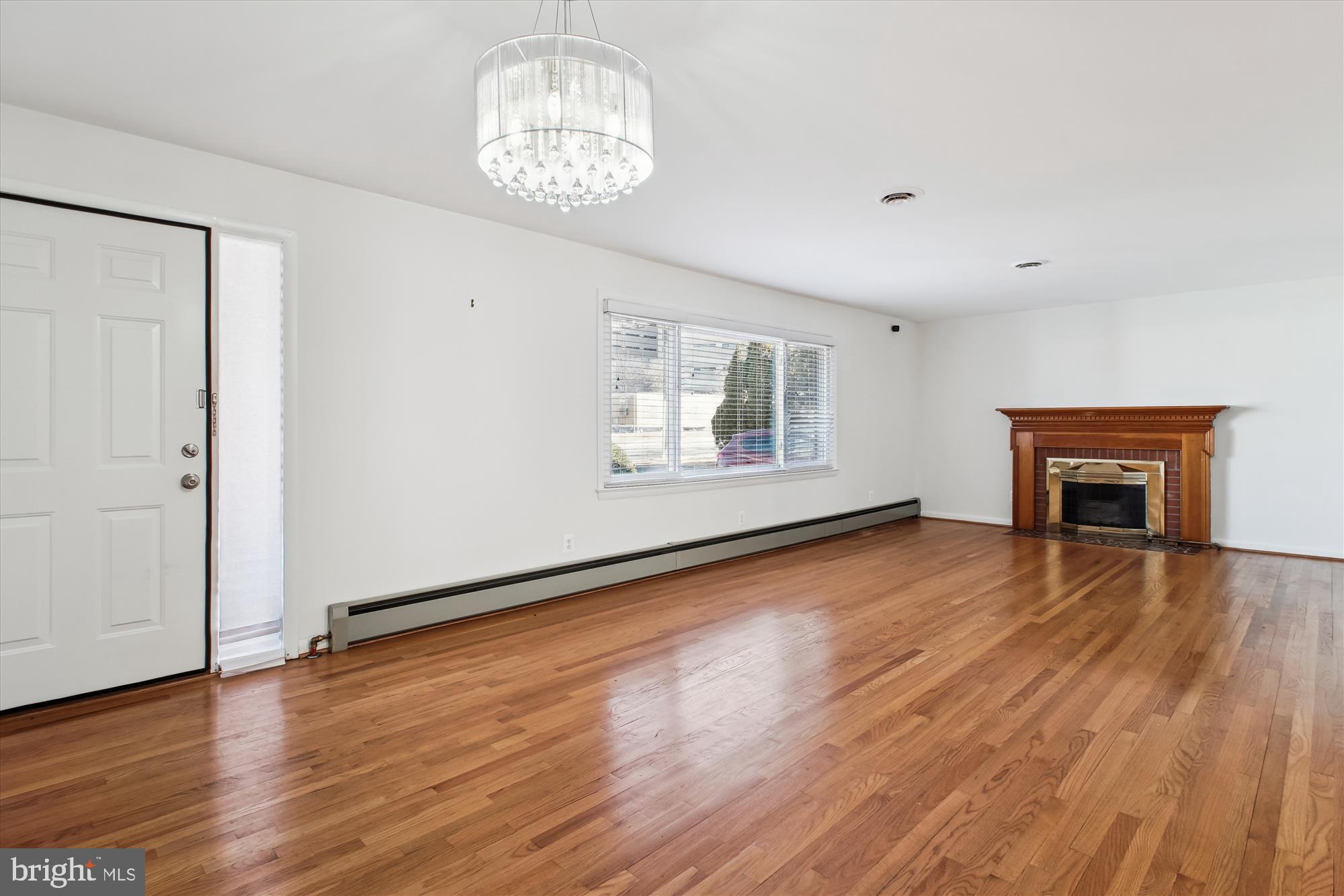 10607 Judicial Drive Fairfax, VA 22030 - Photo 27 of 60 an empty room with wooden floor chandelier and windows