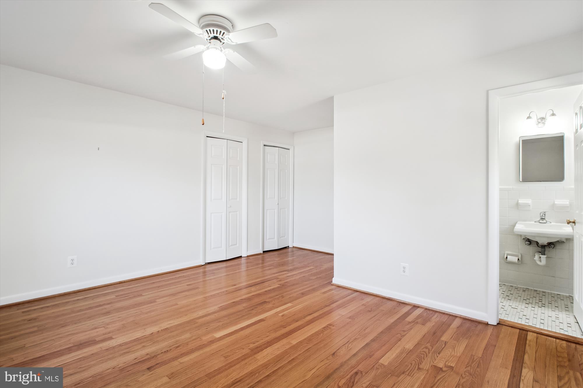 10607 Judicial Drive Fairfax, VA 22030 - Photo 34 of 60 a view of a room with wooden floor and a ceiling fan