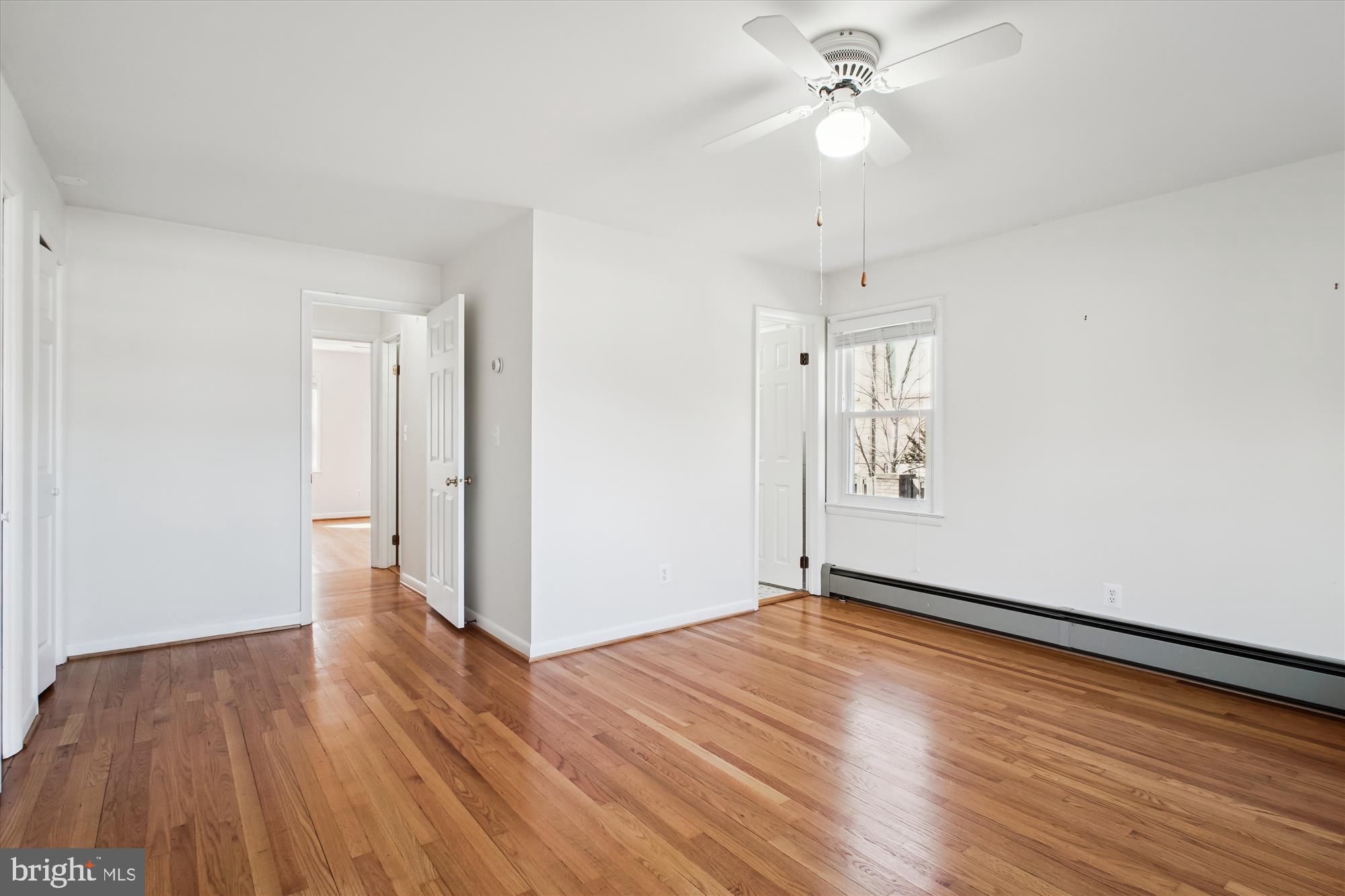 10607 Judicial Drive Fairfax, VA 22030 - Photo 35 of 60 an empty room with wooden floor chandelier fan and windows