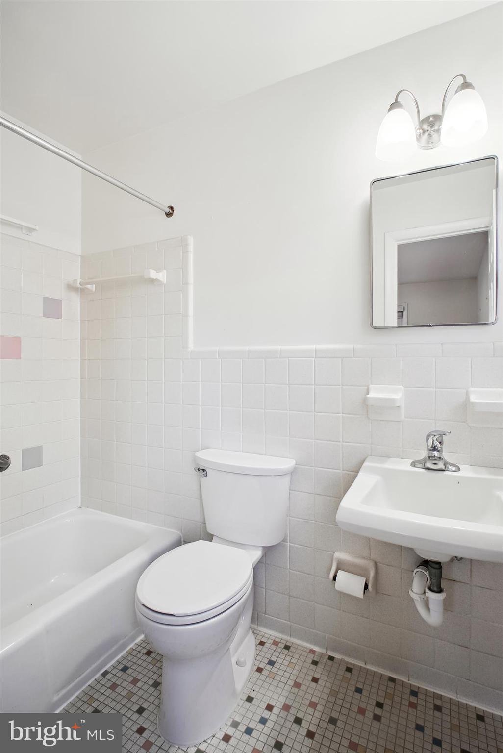 10607 Judicial Drive Fairfax, VA 22030 - Photo 36 of 60 a bathroom with a sink a toilet and shower