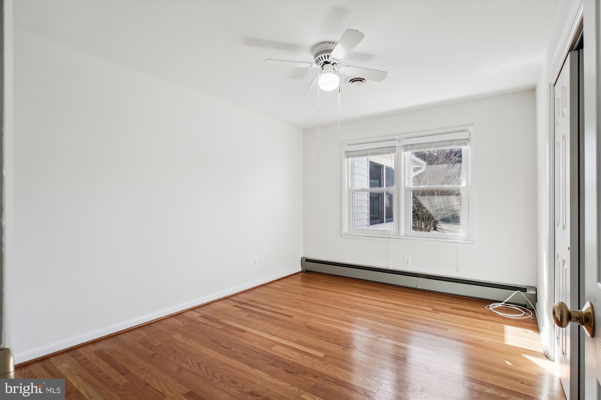 10607 Judicial Drive Fairfax, VA 22030 - Photo 43 of 60 a view of an empty room with wooden floor and a window