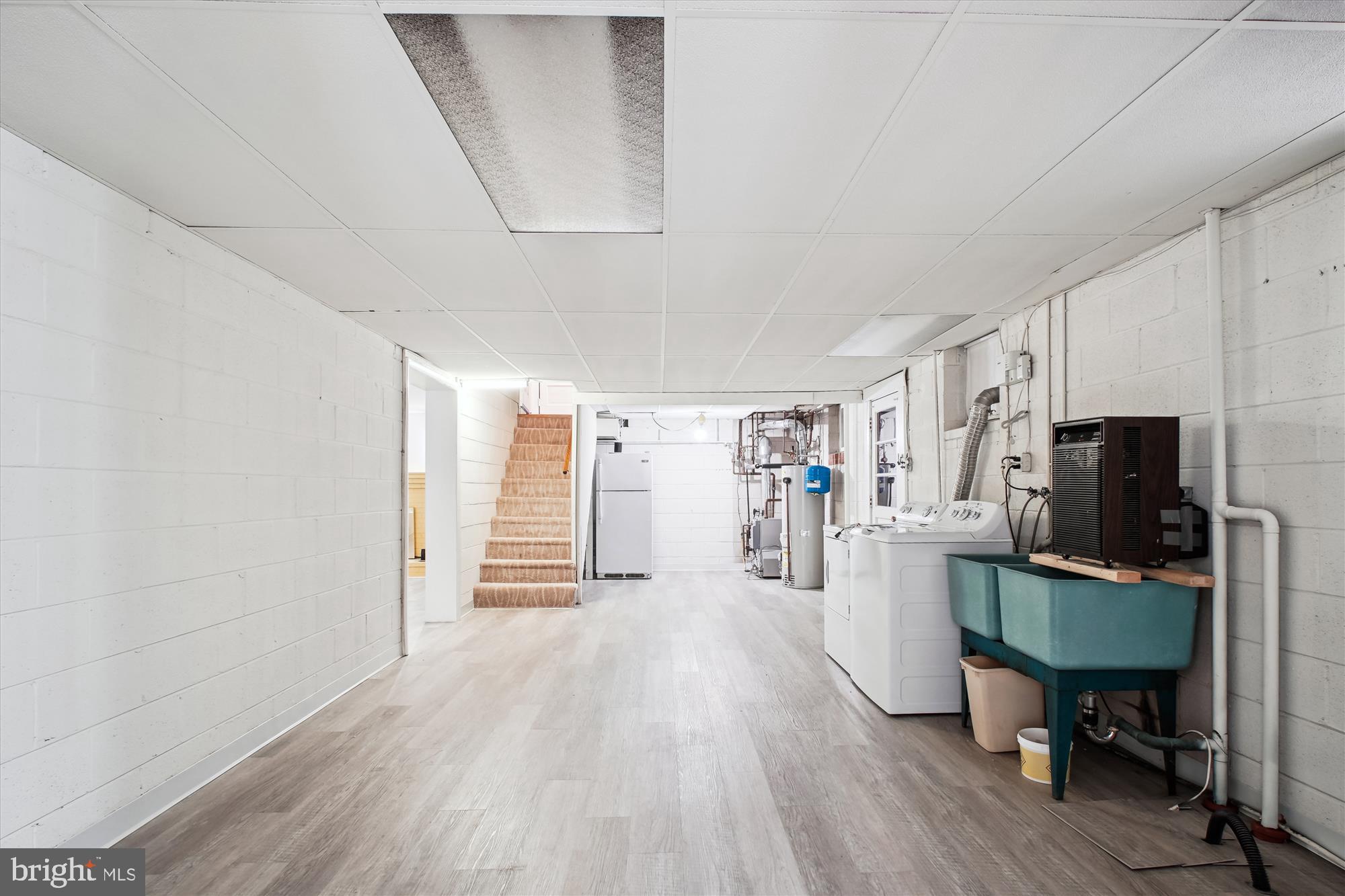 10607 Judicial Drive Fairfax, VA 22030 - Photo 52 of 60 a living room with furniture a flat screen tv and a refrigerator