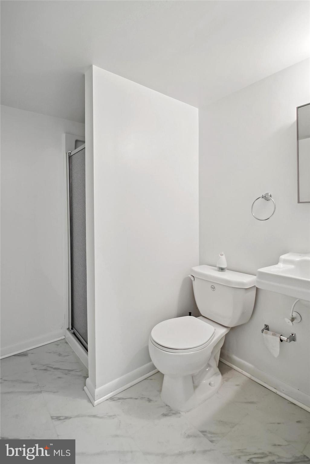 10607 Judicial Drive Fairfax, VA 22030 - Photo 60 of 60 a white toilet sitting next to a bathroom sink