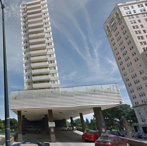 a front view of a building with parking space