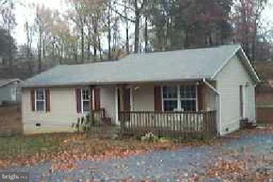 11594 Big Sandy Run Road Lusby, MD 20657 - Photo 1 of 16 a view of a house with a yard and large tree