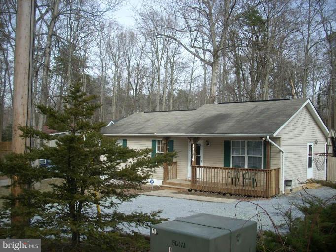 11594 Big Sandy Run Road Lusby, MD 20657 - Photo 2 of 16 a front view of a house with garden