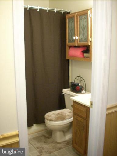 11594 Big Sandy Run Road Lusby, MD 20657 - Photo 11 of 16 a bathroom with a toilet and a shower curtain