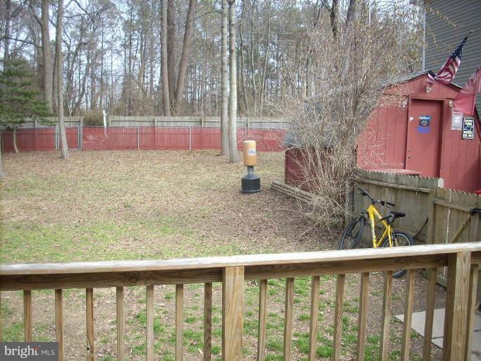 11594 Big Sandy Run Road Lusby, MD 20657 - Photo 13 of 16 a view of a yard with a house and a tree