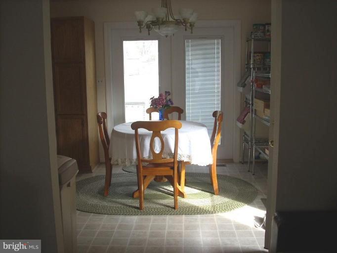 11594 Big Sandy Run Road Lusby, MD 20657 - Photo 5 of 16 a view of a room with a dining table and chairs