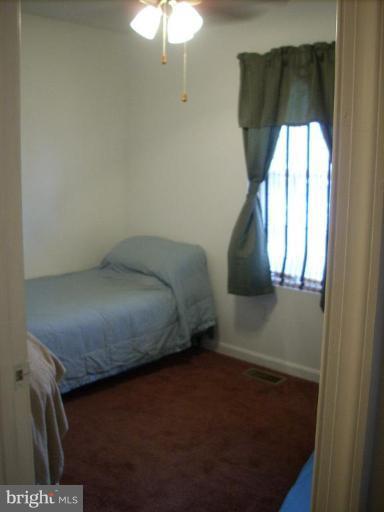 11594 Big Sandy Run Road Lusby, MD 20657 - Photo 8 of 16 a bedroom with a bed and a window