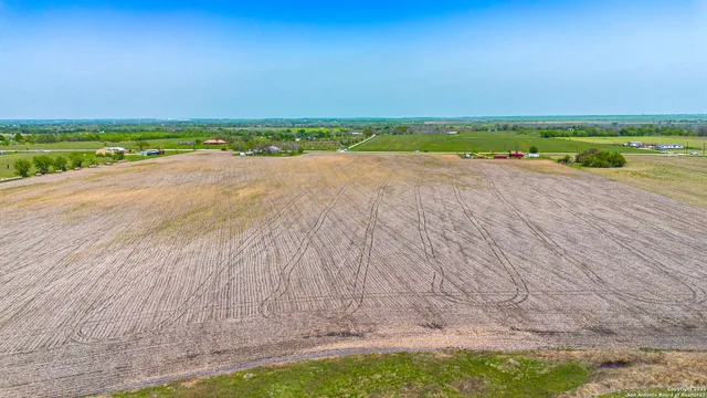 a view of a city street with a big yard
