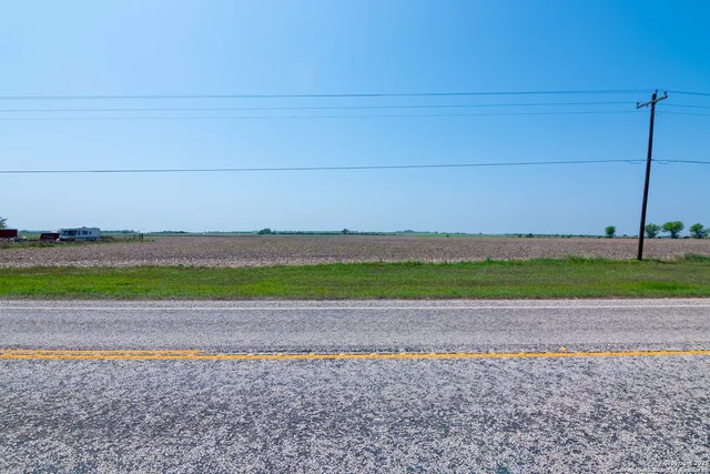 a view of a field with an ocean view