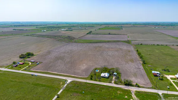 a view of a field with an ocean