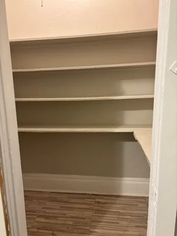 a view of walk in closet with empty racks