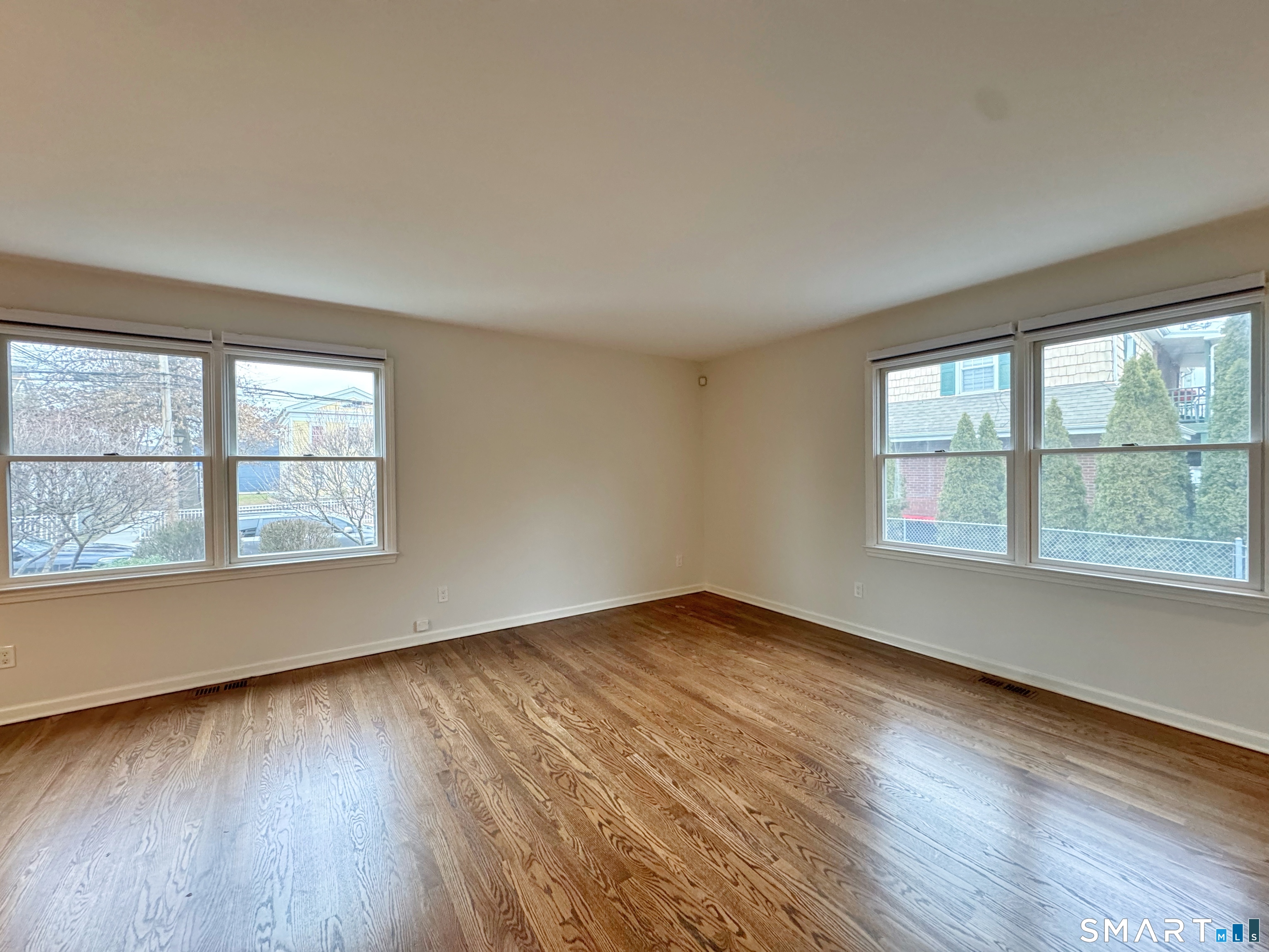 36 Chapel Street, Unit 1 Norwalk, CT 06850 - Photo 4 of 11 an empty room with wooden floor and windows