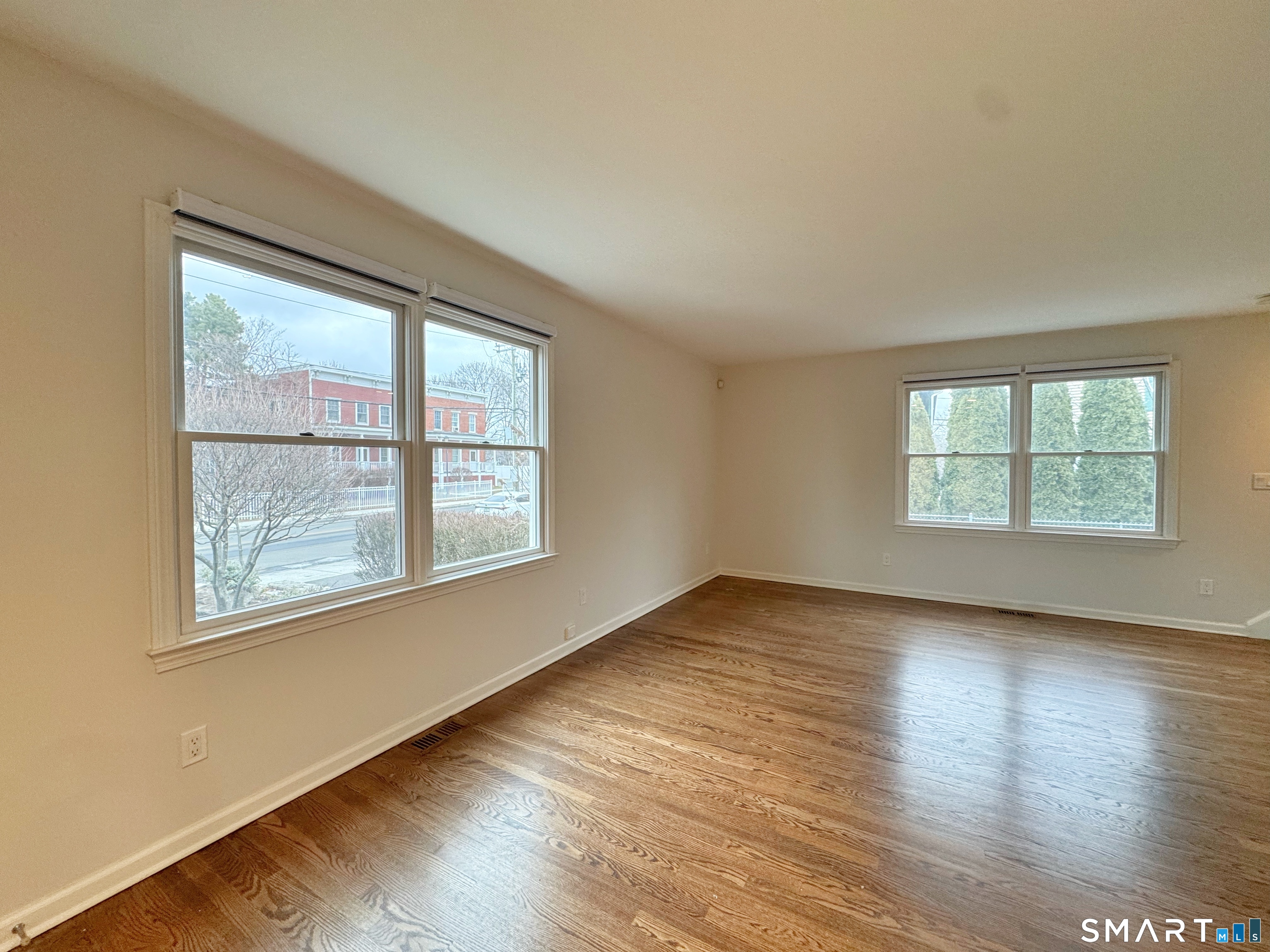 36 Chapel Street, Unit 1 Norwalk, CT 06850 - Photo 5 of 11 an empty room with wooden floor and windows