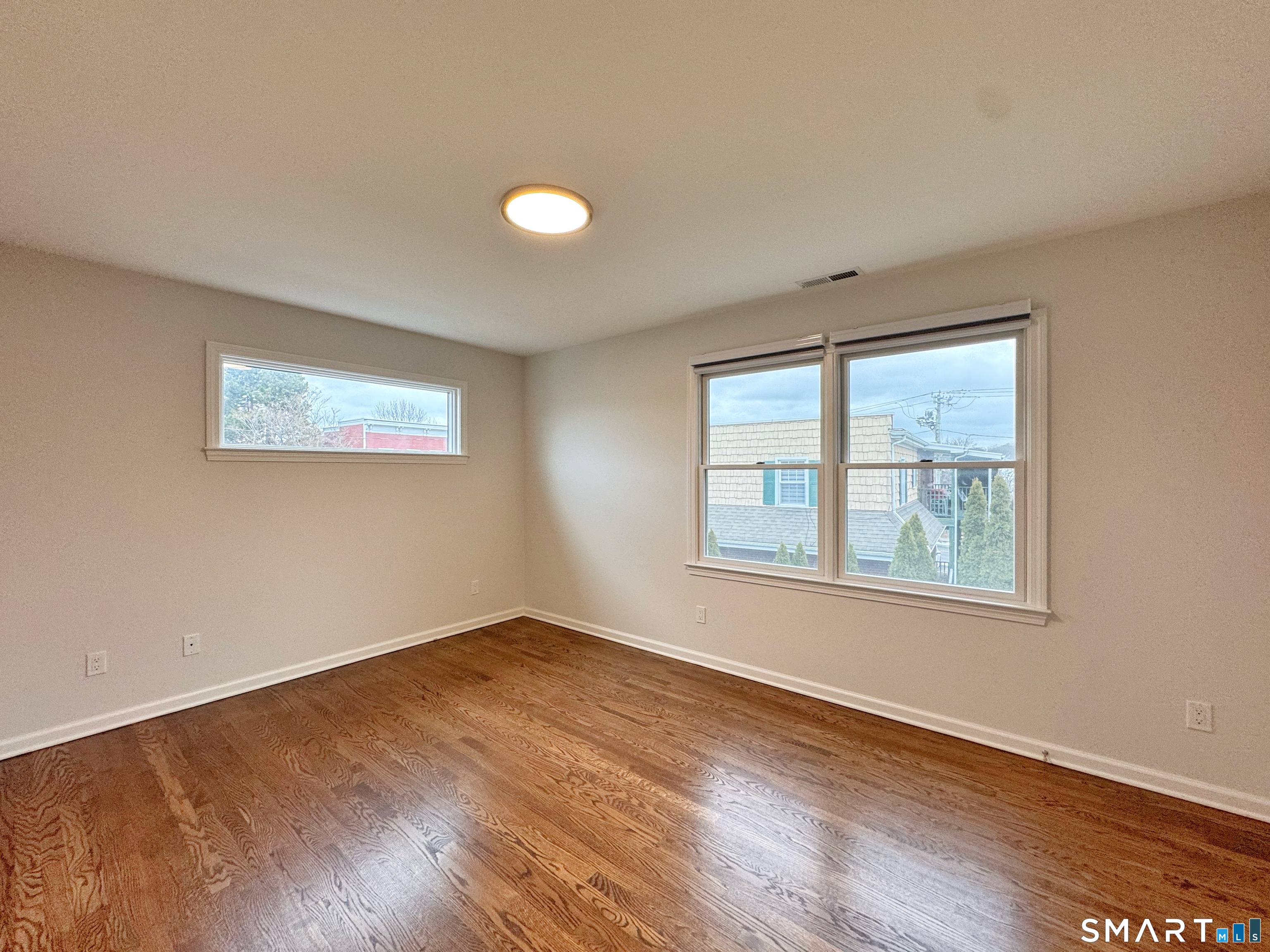 36 Chapel Street, Unit 1 Norwalk, CT 06850 - Photo 6 of 11 a view of an empty room with wooden floor and a window